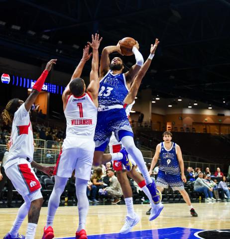 Osceola Magic forward Phillip Wheeler fights through Memphis Hustle defenders on his way to the hoop in Tuesday's 125-122 loss at the Silver Spurs Arena. The Magic were decked out in their holiday celebration uniforms. (Photo/Taylor McFee)