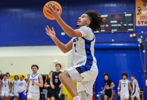 Osceola's Luke McCrimon drives to the hoop for two of his 20 points in Saturday's 63-62 Class 7A regional semifinal loss to Tampa Plant. He and Jordan Mason (in the background) played their last games for the Kowboys. (Photo/Taylor McFee)