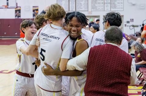 Partners Peyton Williams and Andrew Bradbury celebrate after helping their athletes again win the Florida Unified Basketball state championship (Photo/Taylor McFee)