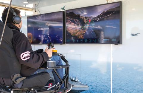 Tohopekaliga High students try their hands at landing a fighter jet on aircraft carrier on the “Fly” Experience and other virtual reality missions at last week’s U.S. Navy Strike Group Experience tour. (Photo/Taylor McFee)