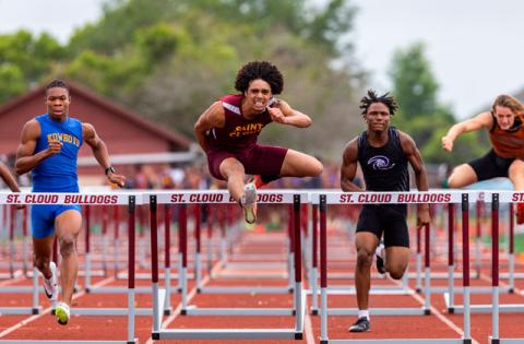 Denzel Hawkins of St. Cloud (center) swept the two boys hurdles events Wednesday at the Orange Belt Conference track meet at St. Cloud High School. (Photo/Taylor McFee)