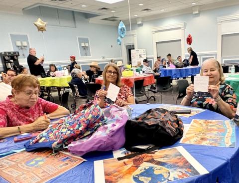 Osceola Council on Aging seniors offer words of wisdom and encouragement to local students for the upcoming school year. The notes and school supplies will fill backpacks that Northbridge University will give out at their Back-to-School Event on August 1. (Photo/Debbie Daniel)