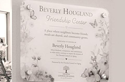 Warren and Chris Hougland unveil the Beverly Hougland Friendship Center plague at the Buen Vecino Ribbon Cutting ceremony. (Photo/Osceola Council on Aging)