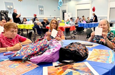 Osceola Council on Aging seniors offer words of wisdom and encouragement to local students for the upcoming school year. The notes and school supplies will fill backpacks that Northbridge University will give out at their Back-to-School Event on August 1. (Photo/Debbie Daniel)