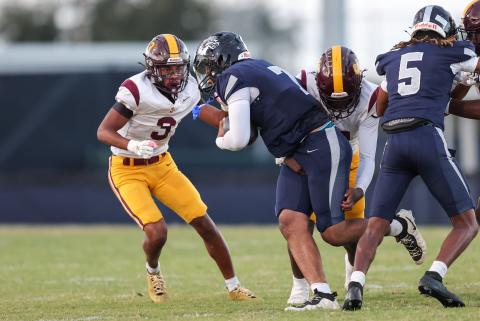 St. Cloud's Stacy Taylor-Irons closes in on Lake Nona quarterback Elijah Nickerson in Friday's 43-8 Lions win. (Photo/Taylor McFee)