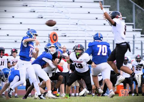 Gateway linebacker Tavian Martinez goes up to defend Harmony quarterback Cooper Halquist's pass in Friday's 34-7 Gateway victory. (Photo/Katie Williams)
