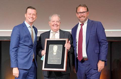 Experience Kissimmee CEO D.T. Minich (center) was recognized at last week’s Florida Governor’s Conference on Tourism in West Palm Beach. (Photo/Experience Kissimmee)