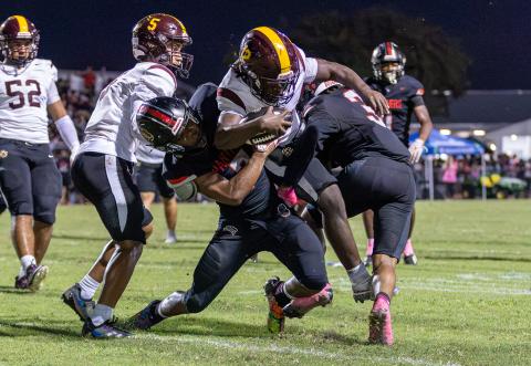Gateway linebackers Jadriell Cedano and Zedekiah Lester converge on St. Cloud running back Eli Manning, who led all rushers with 82 yards in the Bulldogs' 28-21 win Friday over the Panthers. (Photo/Taylor McFee) 