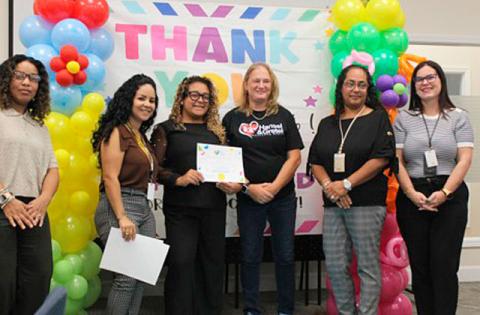 Quality Initiatives Manager Neysha Dominguez and her team award Hansel and Gretel Educating Heart their Certificate of Commendation at the Early Learning Coalition event on Sept. 29. (Photo/Emely Albelo)