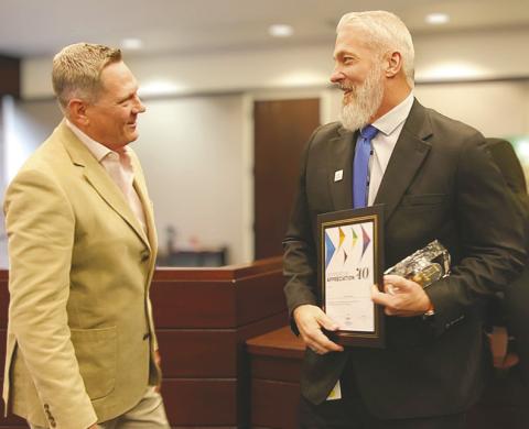 Commissioner Brandon Arrington, named board chairperson for the coming year, presents Osceola County IT Director Rich Van Natta an award for 40 years with the county. (Photo/Osceola County)