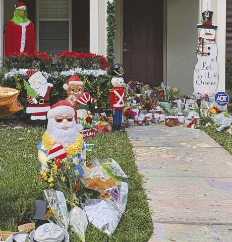 Family, friends, neighbors, and fans have left flowers, balloons, coffee, and other memorabilia outside the home of David Adam Williams, “Adam the Woo,” to honor his passing. (Photo/Jennifer Chalifoux)