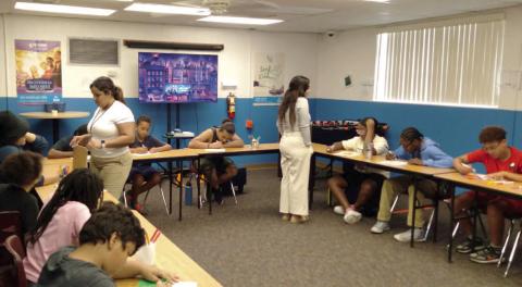 WYE student interns Nomaris Hernandez and Kaitlynn Torres work with summer campers during “Portraits of Who I Am” at the St. Cloud Boys &amp; Girls Club. PHOTO/WYE