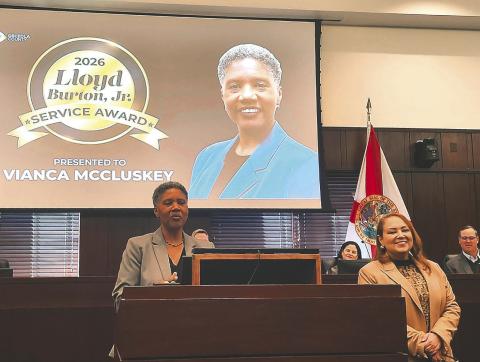 Osceola County Commissioner Viviana Janer presented Florida Department of Health-Osceola County administrator Vianca McCluskey with the Lieutenant Lloyd Burton Jr. Service Award Monday. (Photo/Ken Jackson)