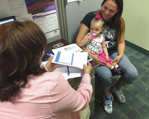Jasmine Sierra works with OCOA Case Manager Damaris Gutierrez to see if she qualifies for its Low-Income Home Energy Assistance Program. PHOTO/OSCEOLA COUNCIL ON AGING