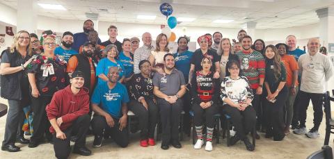 Marco Vivas, the latest graduate of Orlando Health’s WE BUILD internship program for adults with unique developmental and learning abilities, celebrates with his new St. Cloud Hospital teammates. (Photos/Ken Jackson).