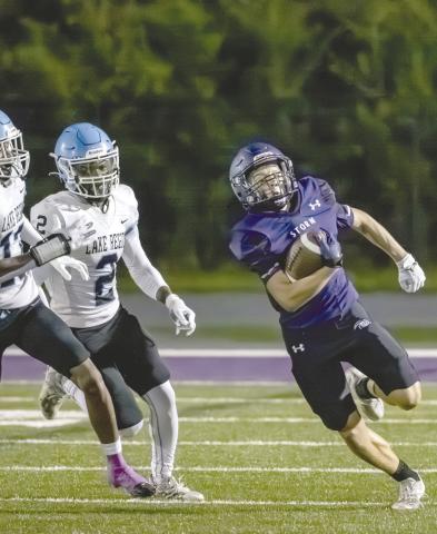 Celebration’s Kobe Orr runs from the Lake Region devense in Friday’s 21-6 Storm win. PHOTO/MARIO CASAMALHUAPA
