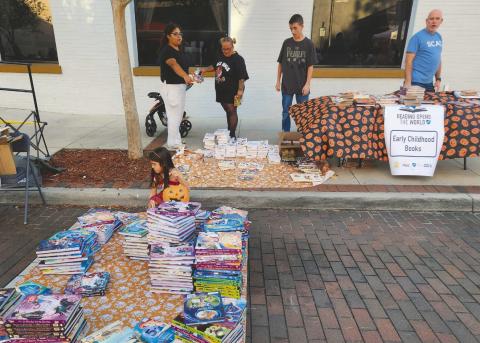 The Florida Education Association and its president Andrew Spar handed out books instead of candy at the Boo on Broadway Halloween event in downtown Kissimmee. (Photo/Ken Jackson)