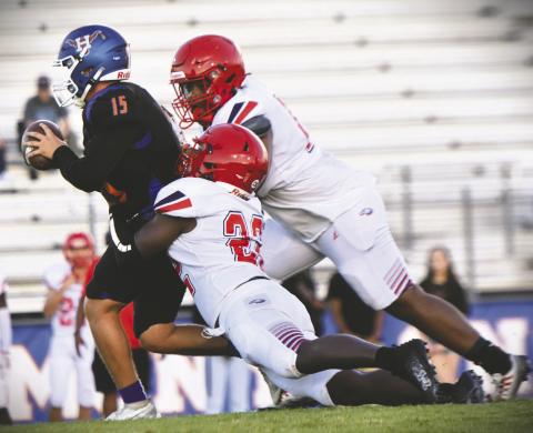 Right photo: Poinciana linebacker Ja’kobe Hines brings down Harmony quarterback Landon Hayes in Friday’s 26-5 Eagle victory at The Ranch Friday. WILLIAMS