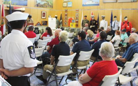 Navy League Cadets and those gathered view a video presentation by Col. Joe Kittinger. PHOTO/TERRY LLOYD