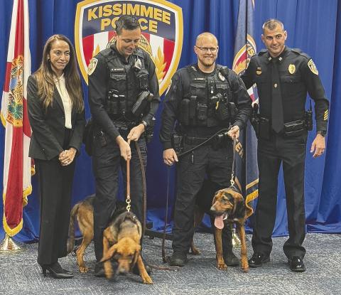 Kissimmee Police Department officers Kyle Bywater (left) and Andrew Cason with bloodhounds Dutchess and Belle, KPD’s two newest members. PHOTO/DAVID CHIVERS