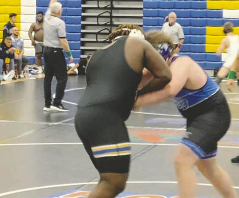 Osceola’s Jaquille Knox (left) battles Wellington’s Liam Higgins in the 285-pound class at the FHSAA state duals championships Friday. SUBMITTED PHOTO