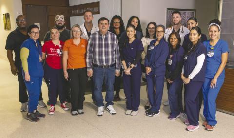 Thanks to quick work by the response care team at Orlando Health Emergency Room—Osceola, César Díaz Lira (fourth from left in front) was able to later reunite with that team that saved his life. (Photo/Orlando Health)